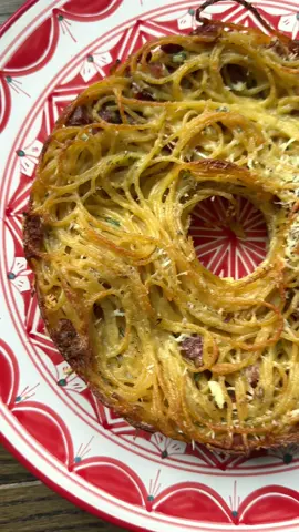 CARBONARA SPAGHETTI PIE is the perfect brunch or game day dish! Full recipe below. Be sure to follow @Jessica Hirsch and I for more! Spaghetti pie is an Italian dish typically made with leftover pasta, cured meats and cheese. It’s a wonderful dish to serve for brunch or in our case, football viewing parties! Enjoy it warm or cold. Carbonara Spaghetti Pie Ingredients: 1 tbsp butter 8 ounces pancetta or bacon diced 1 lb spaghetti 4 eggs 1 egg yolk ½ cup heavy cream ¾ cup milk 2 cup Pecorino Romano ½ tsp salt ½ tsp freshly grounded pepper ¼ cup fresh chopped parsley Instructions: -Preheat oven to 400F -Grease a 9 inch ringed cake pan or bundt pan with butter and set aside. -Dice the pancetta (or bacon) and add it to a room temp pan. Raise the heat to medium and cook the pancetta until the fat has rendered and the pancetta is crispy then turn off the heat. -Cook the spaghetti al dente, strain, add the pasta to the pancetta pan and toss so that it is coated in pancetta fat.  -To a large bowl add the eggs, egg yolk, heavy cream, 1½ cups pecorino Romano, pepper and parsley and whisk. -Add the pasta and pancetta to the bowl with the eggs and mix well.  -Transfer to the greased bundt pan. -Sprinkle remaining pecorino on top and bake for 40 minutes. Let rest for 15 minutes, flip and remove from pan.  -Top with more grated Pecorino Romano and enjoy warm or cold! #Gameday #EasyRecipe #footballfood #brunchrecipes #cookingvideo