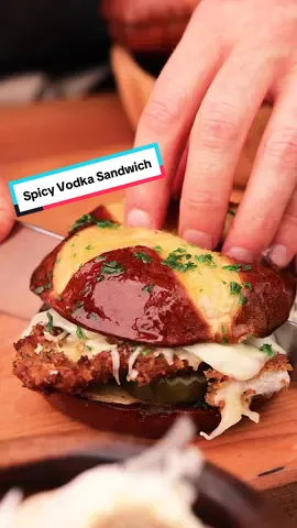 Spicy Vodka Chicken Sandwich. This is a crispy chicken sandwich with melted mozzarella, and dill pickles, served on a garlicy pretzel bun in a pan full of homemade spicy vodka sauce.  INGREDIENTS *Makes 4 sandwiches + 4 pretzel buns, toasted + 6 oz mozzarella, shredded + 8-10 dill pickle slices + 1 lb chicken breasts GARLIC BUTTER + 4 TBSP butter, melted + 1 clove garlic, minced + 1 tsp parsley, chopped.  SPICY VODKA SAUCE + Recipe on website (click link in my bio).  DRY MIX + 1.5 C panko + 2 cloves garlic, minced  + 1/4 tsp dried Italian seasoning + 1/2 C Parmigiano Reggiano, grated + 1/4 tsp salt + 1/4 tsp pepper WET MIX + 2 large eggs + 1/3 C milk FLOUR + 1/2 C all-purpose flour GARLIC BUTTER + 4 TBSP butter, melted + 1 clove garlic, minced + 1 tsp fresh parsley, chopped.  DIRECTIONS +  STEP 1: SAUCE Heat saucier over medium heat for 2 mins, then add olive oil. Add the onions and cook until translucent. Add the garlic and cook until fragrant. Add the tomato paste and cook for 1-2 minutes. Add vodka to deglaze, then reduce heat to medium-low. Add remaining ingredients. Simmer for 10 mins. Remove from heat.  + STEP 2: CHICKEN Preheat oil to 350°F in a skillet or deep pan. Slice chicken into cutlets, about 1/4-1/2 inch thick. + STEP 3: FLOUR & DRY MIX To a plate, add flour. Combine the panko, garlic, Parmigiano Reggiano, Italian seasoning, salt, and pepper on a second plate and mix well.  + STEP 4: WET MIX In a small bowl whisk the egg and milk. Then transfer to a third plate.  + STEP 5: FRY Coat chicken in flour and dust off the excess. Dip chicken in wet mix, then coat with dry mix. Press the cutlet firmly into dry mix then shake off the excess. Carefully place chicken in the oil and cook to an internal temperature of 165°F. Remove chicken from oil, place on a wire rack, season with flaked sea salt. Add mozzarella cheese and cover with a tray or plate to allow the steam to melt the cheese. + STEP 6: SANDWICH Add the pickles, chicken, and then brush bun with garlic butter. Cut sandwich in half. + STEP 7: SERVE To a preheated skillet, add the sauce, then add the sandwich (cut side down). 