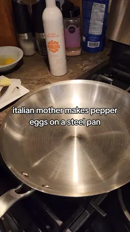 italian mother makes authentic green pepper eggs on a stainless steel pan