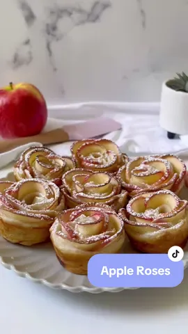 Apple roses have got to be the cutest sweet treat! 💘 Ingredients: -2x apples  -2x puff pastry sheets -Jam of choice   -Cinnamon (optional) -1 tbsp lemon juice  -icing sugar to sprinkle on top  Method: -Preheat oven to 190C. -Cut apples in half and remove the core. -Slice the apples into thin slices. -Add apple slices to a bowl of water and lemon juice. Microwave for 4-5 minutes or until softened.  -Carefully drain the apple slices and pat them dry. -Cut each sheet of puff pastry into 3 even strips (6 total). -Spread jam onto the pastry strips and then place the apple slices along the top. Sprinkle with cinnamon. -Fold the puff pastry in half to cover the apple slices. -Roll the pastry and apples from one end to the other end of the pastry. Place the apple roses into a muffin tin.  -Bake at 190C for 25-30 or until pastry is golden brown. -Once cooled sprinkle with icing sugar. Happy Baking! #appleroses #applepastry #appledessert #pastry #baking 