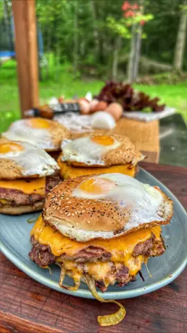 Smash burger topped with crispy white onions and a zesty mustard hot sauce, all tucked inside one-of-a-kind egg-in-a-hole bagel buns!