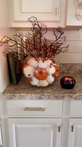 Halloween centerpiece idea!🎃🎃 I used a large bubble vase, added a smaller vase in the center, then filled it with pumpkins, and added some branchy light up stems!🎃 #falldecoration #falldecorating #falldecor #fallhome #halloweendecor #fallhomedecor #falldecorideas #spookyseason #spookyszn #halloweeniscoming 