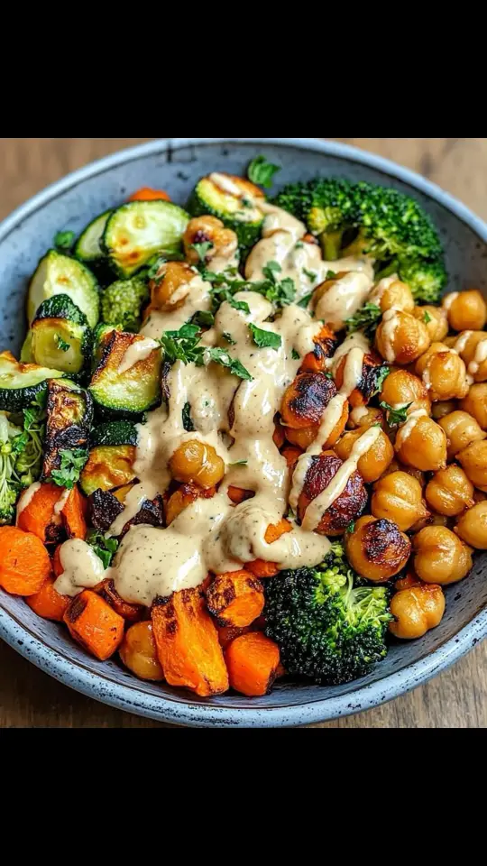 Ingredients: For the Roasted Veggies: 1 zucchini, sliced 1 carrot, sliced 1 broccoli crown, cut into florets 1 red onion, quartered 1 can chickpeas, drained and rinsed 2 tablespoons olive oil 1 teaspoon smoked paprika Salt and pepper, to taste For the Maple Dijon Tahini Dressing: 1/4 cup tahini 1 tablespoon Dijon mustard 1 tablespoon maple syrup 2 tablespoons lemon juice 2 tablespoons water (or more, as needed, for thinning) Salt and pepper, to taste For the Bowls: 2 cups cooked quinoa or rice Fresh parsley or cilantro, chopped (for garnish) Preparation: Step 1: Roast the Veggies Preheat your oven to 400°F (200°C). Prepare a large baking sheet by lining it with parchment paper or lightly greasing it with oil. In a mixing bowl, toss the sliced zucchini, carrot, broccoli florets, quartered red onion, and chickpeas with olive oil, smoked paprika, salt, and pepper until evenly coated. Spread the mixture out in a single layer on the prepared baking sheet. Roast in the preheated oven for 20-25 minutes, or until the vegetables are tender and caramelized, and the chickpeas are slightly crispy. Step 2: Make the Dressing While the vegetables are roasting, prepare the dressing. In a small bowl, whisk together the tahini, Dijon mustard, maple syrup, lemon juice, and water until smooth. Adjust the consistency by adding more water if needed, a teaspoon at a time, until the dressing is pourable but still thick. Season with salt and pepper to taste. Step 3: Assemble the Bowls Divide the cooked quinoa or rice evenly among four serving bowls. Top each bowl with a generous portion of the roasted vegetables and chickpeas. Step 4: Garnish and Serve Drizzle the bowls generously with the maple Dijon tahini dressing. Garnish with freshly chopped parsley or cilantro for added freshness and color. Serve immediately and enjoy the delightful combination of flavors and textures!