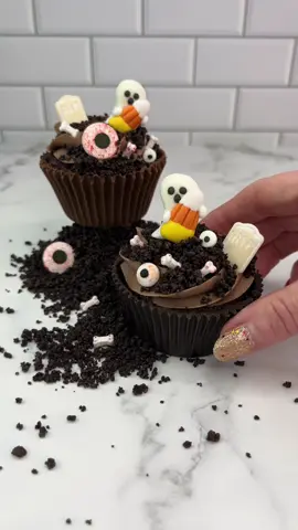 Chocolate cupcake wrappers 👻🍫🎃 Yes 🙌🏻 you can eat the lot 🍫🧁 If you have hot hands 🔥👋🏼 then you should serve them in a bowl 🥣🫠 🍫 Add a tbsp of chocolate candy melts to the bottom of a cupcake liner. Use a brush to spread the melts up the sides of the liner. Allow to set at room temperature. 🍫 Add extra chocolate melts and repeat then allow to set in the fridge.  🍫 Remove the paper liner. Use tweezers if it’s difficult to tear the liner. 🍫 Push a baked cupcake  into the chocolate cup. 🍫 Add a swirl of chocolate buttercream and then some crushed Oreo crumbs. 🍫  Add some Halloween decorations to the top and enjoy 💀👻🎃 #HalloweenTreats #cupcake #cakeartist #cakedecorating #cakedbyrach #chocolate #cutebaking #halloweenbaking 