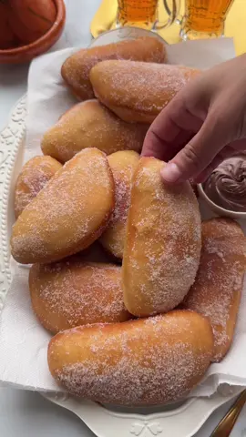 SUGAR DONUTS FILLED WITH CHOCOLATE #chocolate #donuts #sugardonuts #sweet #tasty #Recipe #foryou #fyp #foryoupage DOUGH 190 ml milk (lukewarm) 7 g instant yeast (1 tablespoon) 30 g white caster sugar 16 g vanilla sugar (or vanilla extract) 35 g unsalted butter 1 egg (medium) 400 g flour (all-purpose) 4 g salt (⅔ teaspoon) FILLING 200 g chocolate spread COATING Granulated sugar Add the lukewarm milk, instant yeast, white caster sugar, and vanilla sugar to a large bowl. Mix well. Add the melted butter and beaten egg, and whisk until combined. Then, add the flour and salt. Mix and knead the dough for 10-12 minutes until smooth. Cover the dough and let it rise for 1 hour in a warm spot, or until it has doubled in size. Deflate the dough (I like to punch it) and divide it into 12 equal pieces, about 58 grams each. Shape each piece into a ball. Roll each ball of dough into a flat circle. Place the chocolate spread into a piping bag (or use a sandwich bag). Fill the dough with a small amount of chocolate spread and fold the dough over. Press the edges firmly with your fingers to seal the filling inside. Let the filled dough rise again for 30 minutes, or until they’ve doubled in size. Heat a layer of sunflower oil in a frying pan over medium heat (175°C). Fry the dough until golden brown on both sides. While they are still warm, roll them in granulated sugar.