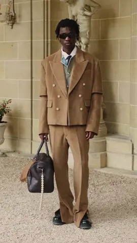 MOUTY FW24 « SPIRITUAL REALITY » CAMEL SUIT  This suit combines refined details such as pearl buttons, an elegant Italian collar, and a discreet slit at the hem of the flare pants. The bold, structured silhouette, enhanced by double sleeves, reflects the perfect harmony between street tailoring and soft masculinity. Available online & in store. #FW24 #MOUTY #spiritualreality #fyp #fashion #men #suit 