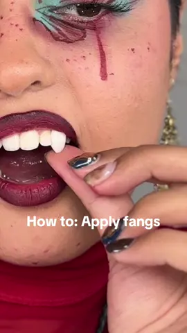 Easily apply fangs for halloween. I used a denture glue from amazon, lasted me all day! Trick is to hold it for a minute or so once you apply to secure up towards the gum  #vampire #halloweenhack #crazymakeup #vampirefangs #vampiremakeup 