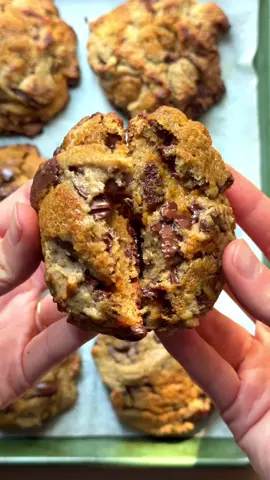 A RECIPE IN CAPTION BC I CARE ABOUT U (also I would love  for you to get my cookbook where this recipe lives, “Justine Cooks” which comes out in one! day!) For the cookies: Brown 4 tbsp/57 grams of salted butter until dark brown, set aside to cool. Beat together 4 tbsp/57 grams of softened salted butter with 1/2 cup/100 grams of dark brown sugar, 1/4 scant cup/50 grams granulated sugar, 1 teaspoon vanilla paste. Add in the browned butter and beat until fluffy, then add in 1 egg and beat until lightened in color.  Add 1 cup/140 grams all-purpose flour, 2/3 cup/90 grams dark rye flour, 1 1/2 tsp baking powder, 1/4 tsp each of cinnamon, clove, all spice and nutmeg, 1 tsp Diamond Crystal kosher salt and mix until just combined. Add in 100 grams of chopped chocolate and mix.  For the caramel, add 2 tbsp softened salted butter, 2 tbsp pumpkin purée (the least watery you can get), 2 tsp white miso and 4 tbsp lightly packed brown sugar. Whisk until smooth (if it breaks a little, that’s ok! It will smooth out in the oven).  Scoop the dough in 55 gram mounds onto a lined sheet pan. Smash down the mounds a bit and add 1/4 tsp “pockets” of the caramel in dots on each of the mounds, making sure to stay away from the edges. Each mound will get four dots. Top with another 50 grams of dough and repeat adding pockets of caramel. So each cookie will get about 2 tsps of caramel.  Chill in the fridge for 2-4 hours, then bake at 425°F until golden but not dry, 8-11 minutes. 