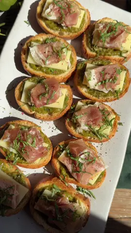 The easiest 2-bite crostini appetizer with @barilla pesto, @Cabot Creamery Cooperative extra sharp cheddar & prosciutto! #ad RECIPE below 👇 Crostini are our go-to holiday appetizer – they’re SO easy to assemble, they’re always a hit and they’re absolutely delicious!  These ones are topped with:  🌱 Barilla Creamy Genovese Pesto for a creamy, flavorful base made with Italian basil & Parmigiano-Reggiano cheese (our go-to for pasta, too!)  🧀 Cabot Creamery Vermont Extra Sharp Cheddar Cheese – the ideal snacking cheese, in my opinion 😍  🥓A slice of prosciutto (optional if you’re vegetarian!)  Plus a little bit of extra fresh basil & black pepper for topping!  You can find Barilla Pesto and Cabot Cheese at your local Kroger or Albertsons banner store 🛒 Save the full recipe below 👇 and tag us if you give it a try! #BarillaUS #CabotCreamery  Pesto Prosciutto & Cheddar Crostini  Makes 24  Ingredients:  1 baguette, cut into 24 slices  Olive oil, salt and pepper to taste  1 jar (6.2 oz) Barilla Creamy Genovese Pesto  6 oz Cabot Creamery Vermont Extra Sharp Cheddar Cheese, cut into 24 slices 12 slices prosciutto, cut in half lengthwise For garnish: 1/4 cup finely chopped basil, black pepper to taste  Preheat oven to 400˚F.  Brush both sides of the bread with olive oil and season lightly with salt and pepper.  Place on a sheet pan and bake for 5-7 minutes, then flip and bake for another 5-7 minutes, until the baguette is light golden brown and toasted. Remove from oven and let cool completely.  Spread about 1 tablespoon of pesto on each crostini, then top with a slice of cheddar, prosciutto and garnish with basil and black pepper. Enjoy!