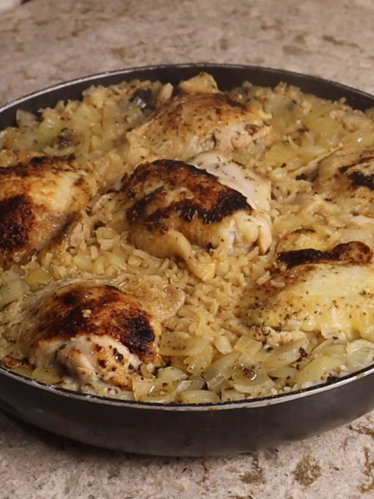 One Pan Chicken & Rice  You will need: 6 bone in skin on chicken thighs ~ $4-5 1 packet of lemon pepper wing seasoning $0.99 1 onion ~ $1 2 cups of rice ~ $1 1 tablespoon of chicken bouillon powder  Total cost > $10 to feed a family The chicken steams as the rice cooks, which make it tender and juicy, meanwhile the rice cooks in the juices from the chicken leaving you with rich, flavorful rice. I like to use whole chicken thighs for this because they are very economical.  I’m using 3 lbs of chicken thighs which I got for a little over $4 Really you can season this with anything you lito use a packet of lemon pepper wing seasoning, I do recommend the wing seasoning as opposed to the jar of standard lemon pepper seasoning, because it’s more lemon than pepper, and I’ll save about a tablespoon what's in the packet to go in the rice. Add the rest to the chicken and and toss it to coat. Preheat a skillet and brown your chicken thighs on both sides for about 4 minutes per side. This does not fully cook the chicken, this is just for color and flavor.  The chicken will cook the rest of the way with the rice.   Then remove them from the pan and add in 1 diced onion and 2 cups of white rice.  Let these sautee together in the drippings that rendered off the chicken and also be sure to scrape up any brown bits on the bottom of the pan. Next I added in 3 cups of water, I would normally do 4 cups of water to 2 cups of rice but I am holding back 1 cup of water because the chicken is going to release some juice as it cooks. To this I added my reserved lemon pepper seasoning, and 1 tablespoon of chicken bouillon powder. Give this one final stir and let it cup up to a boil.  Nestle back in yoru chicken thighs and cover with a lid.  Let this simmer until all of the water has evaporated, you shouldn’t see any liquid or bubbles on the surface.  For me this took 25 minutes.  Then turn off the heat and let it rest for an additional 10 to 15 minutes. Enjoy!  #onepandinner #chickenandrice #lemonpepperchicken #riceandchicken #familydinner #budgetmeals