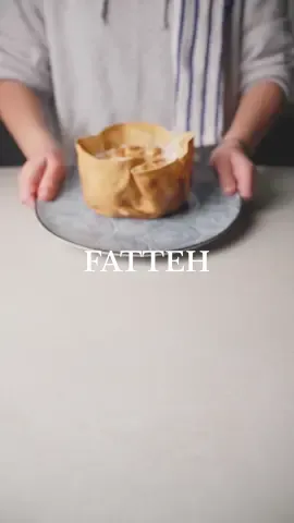 Hummus #Fatteh 🔪🔥  | Recipe #tiktokcookbook #toomacooks  For the Bread Cup  Bake the bread in a cake mold for 10 min the oven make sure you add another mold inside of it to keep the sides vertical    1 cup hummus boiled  2 cups of fried Lebanese bread   For the Laban Sauce : l 3 cups Laban  1 tbsp Tahini  1 tsp garlic paste  1 tsp salt  For the toppings:  Fried Cashews  Or minced meat with pine-nuts