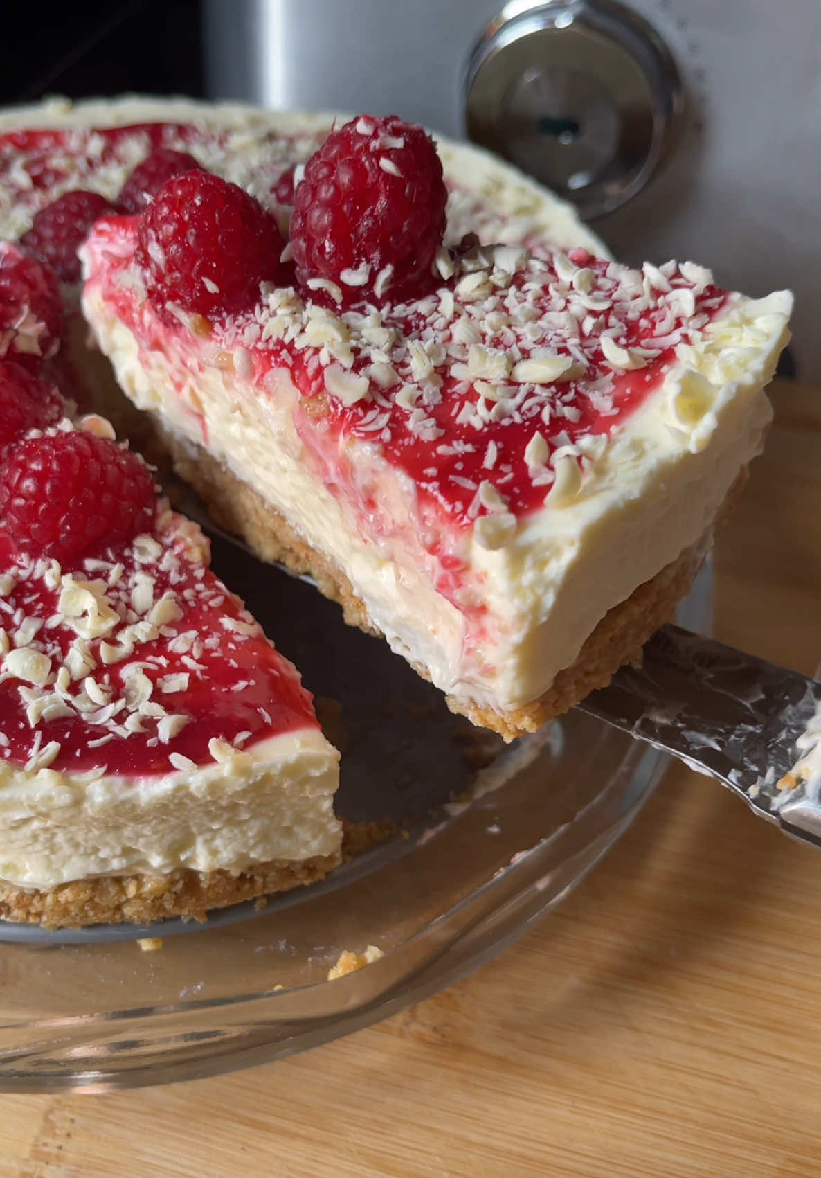 Simple plain cheesecake topped with raspberry sauce and white chocolate :) recipe is from @janespatisserie  For the raspberry sauce I added a pack of raspberries to a pot mixed it with sugar on a low heat until it turned to a sauce, once cooled I added it to the cheesecake :)  Here’s what you’ll need: Biscuit Base * 300 g digestives * 150 g unsalted butter Cheesecake Filling * 500 g full fat cream cheese * 100 g icing sugar * 1 tsp vanilla extract * 300 ml double cream Decoration * 100 g white chocolate * Pack of fresh raspberries * 2 tbsp sugar  #goodfood #cheesecake #dessert #yummy #foodbylaila #fyp 
