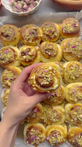 HONEY CREAM CHEESE SWIRLS WITH PISTACHIOS #food #Recipe #honey #creamcheese #swirls #pistachios  DOUGH 175 ml milk (lukewarm) 20 g granulated sugar 8 g vanilla sugar (1 tablespoon) 7 g instant yeast (1 tablespoon) 35 g unsalted butter 25 ml sunflower oil 1 egg (medium) 400 g flour (all-purpose) 5 g salt (⅚ teaspoon) FILLING 16 cream cheese wedges (at room temperature) GARNISH 250 g honey Pistachios (or walnuts) Melt the butter over low heat in a saucepan and let it cool. In a large bowl, add the lukewarm milk, granulated sugar, vanilla sugar, and yeast. Stir well with a whisk. Add the sunflower oil, beaten egg, and melted butter. Mix well. Then add the flour and salt. Mix and knead the dough for 10-12 minutes until it is smooth and elastic. Cover the dough and let it rise in a warm place for 1 hour until it has doubled in size. Place the cream cheese wedges in a bowl and mix until smooth. Divide the dough into two equal parts of about 350 grams each. Dust your work surface with flour and roll one part of the dough into a rectangle. Spread half of the cream cheese over the dough. Repeat with the other half. Roll the dough tightly. Cut into equal-sized pieces. Place the dough rolls (swirls) on a baking sheet lined with parchment paper. Let them rise for 30 minutes or until they have doubled in size. Preheat the oven to 200 °C (390 °F). Bake the swirls for 12-18 minutes until golden brown and cooked through. Check the baking time, as each oven is different. Brush the warm swirls with honey and garnish with chopped pistachios or walnuts.