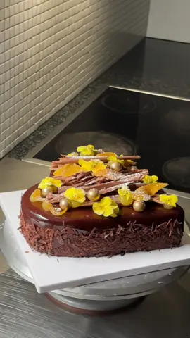 I have a feeling you will love it. #moussecake #orange #citrus  What's the cake? Was never a fan of orange chocolate combinations (and especially mint and chocolate) but I think this cake has changed my mind. It has this rich multi-chocolate layer between moussy and chocolaty with this sharp and fresh orange citrus compote. If you love those flavours, this is the cake for you.  Taste 9.5/10 My visuals 7/10  The layers? Chocolate sponge cake soaked in orange and vanilla, topped with silky dark chocolate ganache, followed by orange compote (citrus peel, orange segments, orange gel, vanilla), dark chocolate mousse, Chocolate sponge cake soaked in orange and vanilla, dark chocolate mirror glaze, chocolate curls, orange gel, yellow flowers, and edible chocolate balls. Full component breakdown on the site.  The tools? The tools I used for this cake are as follows: 22cm x 4.5cm heart-shaped tart ring, 2 piping bags (or reusables) 33cm x 33cm silicone tray mat, spatula, pastry brush, and blender.  Citrus peels: 60g orange peel 135g caster sugar 135g water 1 vanilla bean split in half and seeds scraped out (optional) 1g citric acid (optional) 25g caster sugar Process: Need to boil 3 times with fresh water to take out bitterness. Then cook with sugar water and vanilla till translucent. Pat try, then coat in sugar and citric acid.