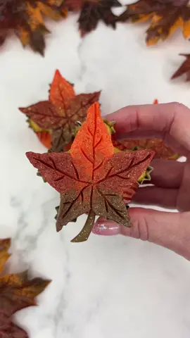 🍁🧡🍁🤎🍁  Turning cupcakes into maple leaves 🍁  I love how they turned out 🍁🧁I wasn’t sure they would work as I imagined… trust the process 😜🍁 🍁 Shape your cupcakes by adding foil balls before baking.  🍁 Use a pointed palette knife to add buttercream and smooth out the centre. 🍁 Screw up a sheet of parchment paper. Then open it out and lay it flat on a baking sheet.  🍁Gently press the cupcakes down onto the paper. 🍁 Freeze for 20 minutes and then peel them away from the paper. 🍁 While the buttercream is still really cold, use a cocktail stick to score the leaf details.  🍁 Make small stems from fondant and push them into the buttercream. 🍁 Spray with edible glitter ✨  Enjoy.  #cupcakes #cakedecorating #cakeart #cakedbyrach #shapedcupcakes #autumn #mapleleaves #fallbaking #cupcakedecorating #cupcakesforanyoccasion 