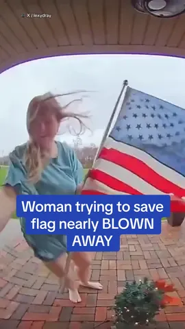 The moment an Ohio woman was nearly blown away while attempting to save an American flag was captured in hilarious doorbell footage. The 24-year-old woman was working from her Columbus home on Wednesday when a wild wind storm hit the area - leading to the American flag propped up outside her front door whipping around like crazy. She bravely went outside in an attempt to take it down - but the wind almost took her instead. ‘Best part about this is I'm the most unpatriotic person ever,' she wrote on X. 'Yet, I was fighting for my life.'  🎥 X / lexydray #ohio #storm #columbus #funnyvideo 
