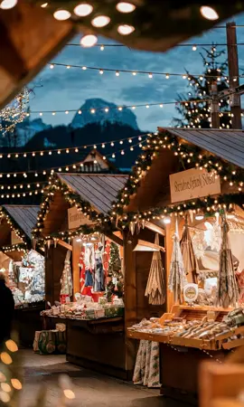 Experience the enchanting Christmas market in Salzburg at night, where traditional wooden stalls glow with twinkling fairy lights against the stunning backdrop of the Alps Immerse yourself in holiday cheer with festive music filling the air #ChristmasMarket #Salzburg #WinterWonderland #Alps #HolidayCheer