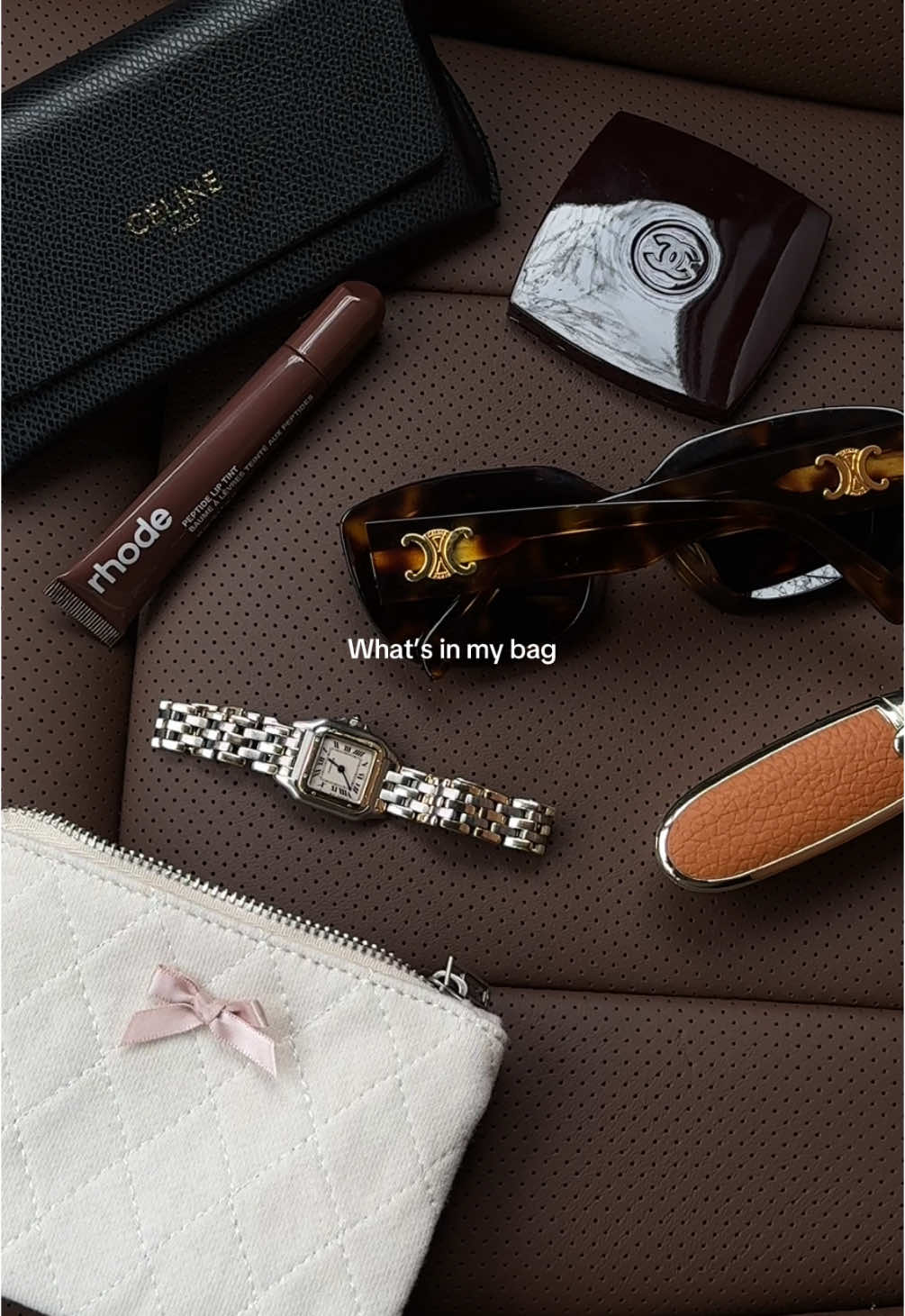 Whats in my bag Xx 🤎 #guerlainlipstick #cartier #cartierpanthere #cartierwatch #chanel #rhode #rhodeliptreatment #whatsinmybag 