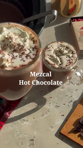 Day 4 of 12 Days of Batched Cocktails ☕️🍫🎄 Batched Mezcal Hot Chocolate (Serves 10) Ingredients: 6 whole milk 2 cups heavy cream 1½ cups chopped dark chocolate (2 bars, 70% cocoa or higher) ½ cup unsweetened cocoa powder ½ cup brown sugar (or to taste) 1 tsp vanilla extract 2 cinnamon sticks  ¼ tsp cayenne pepper (optional) 1 ½ cups mezcal  Whipped cream and chocolate shavings, for garnish  In a crockpot, combine the milk, heavy cream, chopped dark chocolate, cocoa powder, sugar, vanilla extract, cinnamon, and cayenne pepper. Stir to mix. Set the crockpot to low heat and cook, stirring occasionally to ensure the chocolate melts evenly and doesn’t stick to the sides.  Once the hot chocolate is smooth and warmed through, stir in the mezcal. Let it heat for an additional 15 minutes on low. Ladle the hot chocolate into mugs. Garnish with whipped cream and chocolate shavings. . . . #cocktailrecipes #EasyRecipes #cocktail #drinksathome #holidaycocktails #hotchocolate #mezcalhotchocolate #batchedcocktails #batchedrecipe 