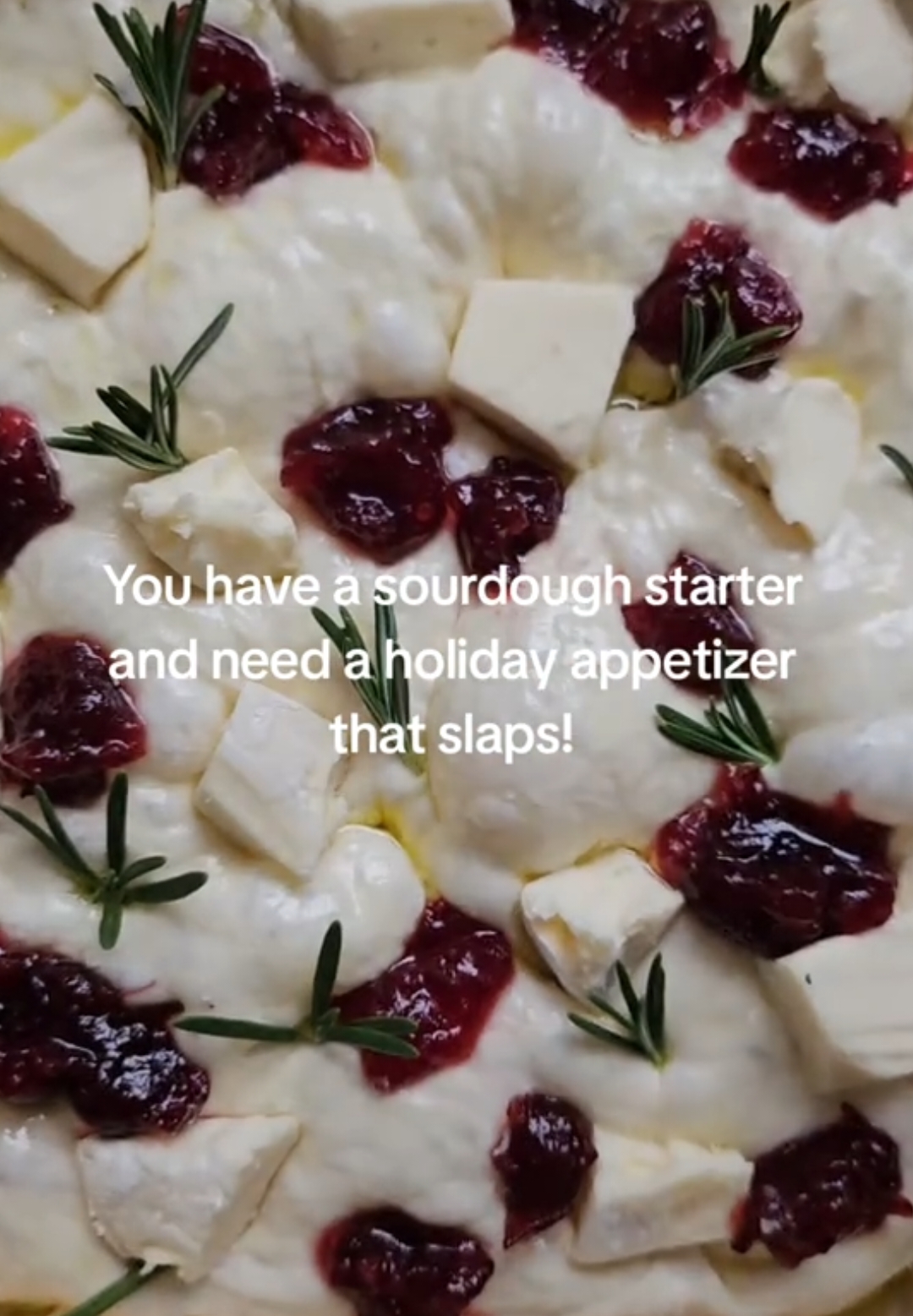 I've seen Cranberry, Brie & Rosemary Sourdough pull-apart bread all over my feed as a holiday appetizer, but I thought I'd try it as focaccia and it didn't disappoint 👌🏻. Use your favorite sourdough focaccia recipe, or here's mine 👇🏼 Ingredients: 400 (1 2/3 cups) warm filtered water 100g (1/2 cup) active sourdough starter 500g (3 3/4 cups) bread flour (or high protein all-purpose flour) 10g (2 tsp) salt 24g (2 tbsp) olive oil for coating + drizzling 1 wheel of Brie cheese (rind cut off and cubed) Cranberry sauce (measure with your heart) Sprigs of fresh rosemary Flakey salt Instructions: - The night before, mix your warm water and sourdough starter until frothy. Add your flour and salt and mix until there's no clumps. Keep in mind this is a high hydration dough, so it will be a wet dough. Cover your bowl and let rest for 30 minutes.  - Do 2 series of stretch and folds 30 minutes apart. After your last stretch and fold, transfer to an oiled bowl or container (around 14g of olive oil). Let bulk ferment on your counter overnight at room temperature.  - The next morning, your dough should be doubled in size and light and puffy. Grab your baking dish. I like to line mine with parchment paper. Add a layer of olive oil on the bottom, add your dough, and gently pull the dough to the shape of the dish (don’t pull too hard). Cover and let rest for a 2nd rise on your counter for a few hours (I let it rise for 4 hours). If you aren't ready to bake that day, you could stick it in the fridge and then pull it out and resume for the 2nd rise.  - Your dough will be ready when it’s expanded, bubbly, and jiggly. Preheat your oven to 425F. At this point, put your chopped Brie in the freezer (this helps bake evenly). - Once your oven is ready, drizzle your dough with a healthy dose of oil (I eyeball it). Dimple your dough with your fingertips. Add your chopped Brie (from the freezer), cranberry sauce, Rosemary sprigs, and flakey salt. Bake for around 30-35 minutes (or until golden).  For more holiday inspired recipes and homemade sourdough gifting ideas, check out my guide in my bio. 🎄❤️ #sourdoughstarter #holidayappetizer #sourdoughrecipe  #sourdoughfocaccia 