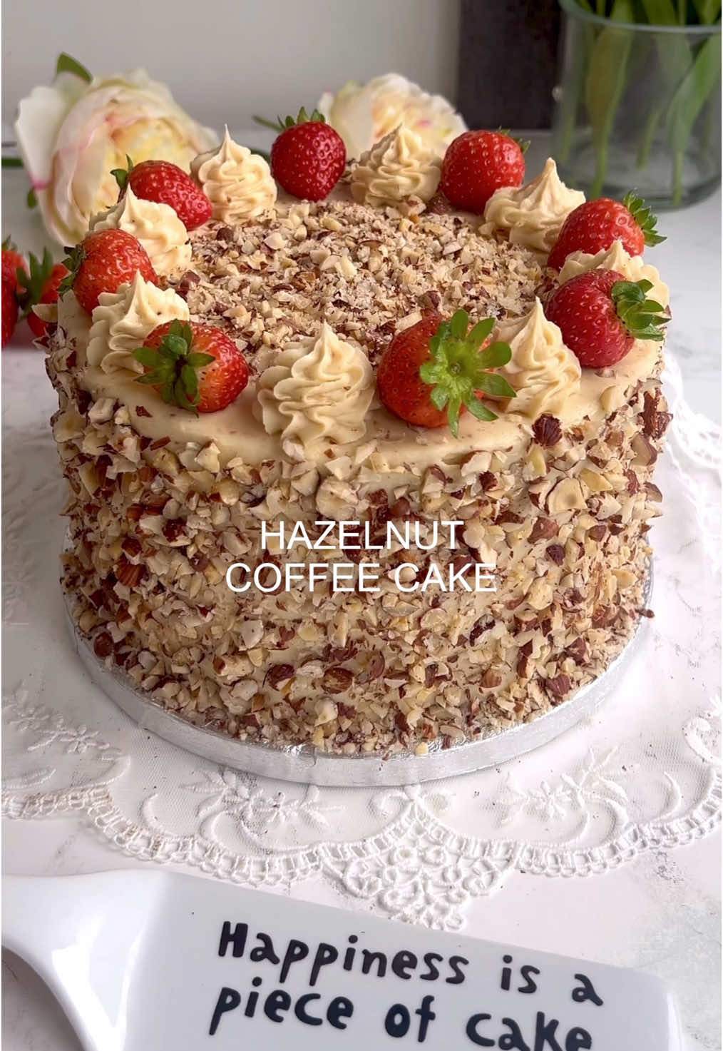 HAZELNUT COFFEE CAKE 🍰🌰☕️ This stunning Hazelnut Coffee Cake is crunchy, creamy, and delicious! It has layers of coffee-flavored cake, hazelnut ganache, crushed hazelnuts, and strawberries. Serve at birthdays and other special occasions.  #yummydesserts #christmasmenuideas #coffeecakerecipe #coffeecake #coffeecakedecorating #hazelnutcake #hazelnutganache #bakingtiktokrecipe #dessertideas #birthdaydessertideas