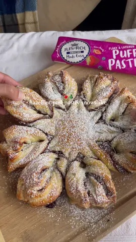 #sponsored Hazelnut Puff Pastry Snowflake made with @Jus-Rol North America puff pastry!🎄  I love how quick and easy this dessert is, and Jus-Rol makes it even easier with their ready-to bake dough. I used to always forget to thaw my puff pastry dough beforehand but with Jus-Rol, there’s no thawing required!😌 #AmazingMadeEasy Find Jus-Rol Puff Pastry in the refrigerated dairy case in a store near you at the link in my bio! You can also comment YUM for 50% off Jus-Rol Puff Pastry straight to your inbox! Ingredients: - 2 sheets @jus_rol_northamerica puff pastry, cut into a large circle  - Hazelnut spread - 1 egg beaten with 1 tbsp water, for egg wash - Powdered sugar, for topping Directions: - Preheat oven to 425 F, and set aside a baking tray. - Evenly spread a generous amount of Nutella over one of the pastry sheets.  - Place the other sheet directly on top. - Place a circle object in the middle of the circle pastry. Using a knife, cut the dough into 16 equal pieces (the best way to cut the dough, is to cut in half, then cut each half in half again and again and again, until you get 16 strips) - Next, working on 2 dough strips at a time, twist each strip outwards then pinch the ends to connect 2 strips together. Repeat with the rest of the strips. - Bake on included parchment paper for 15-20 minutes, or until it turns into a golden color. - Remove pastry from the oven and dust powdered sugar over the top. Enjoy while it’s warm. #EasyRecipes #ChristmasRecipes #bakingszn #PuffPastryJus-Rol #EasyBaking #christmasdessert #holidayrecipe 