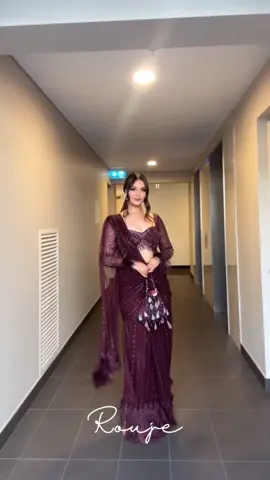 It's all in the details babe✨ Natasha Shah owning the spotlight in Zehrin saree set. ZEHRIN - Aubergine tulle pre-pleated concept-saree hand embroidered with crystals and buggle beads, adorned with feather detailing in pallu and skirt bottom, and embroidered blouse with tassels at waist and back and feather detailing at sleeves, along with feathered shoulder cape. Ethereal Dreams Discover the collection: Online at Roujeofficial.com Calcutta | Hyderabad #roujeofficial #fyp #saree #browntiktok #desitiktok #indiantraditionalwear #receptiondress