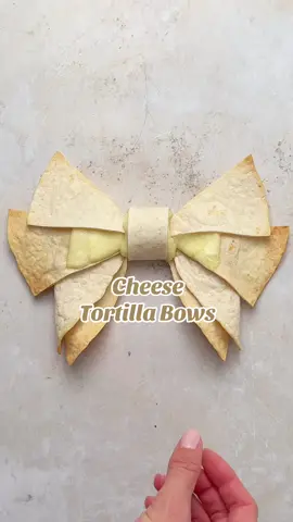 Tortilla bows: the cheese version - see the cheese pull at the end! 🎀🧀 Bake in the oven until the tortilla is golden and the cheese melted - a fun and delicious Christmas snack or lunch idea #CheeseLoversUnite #TortillaIdeas #SnackInspo #FestiveFlavours #easychristmasfood #christmas #tortillas #ediblebows #snacks #fyp 