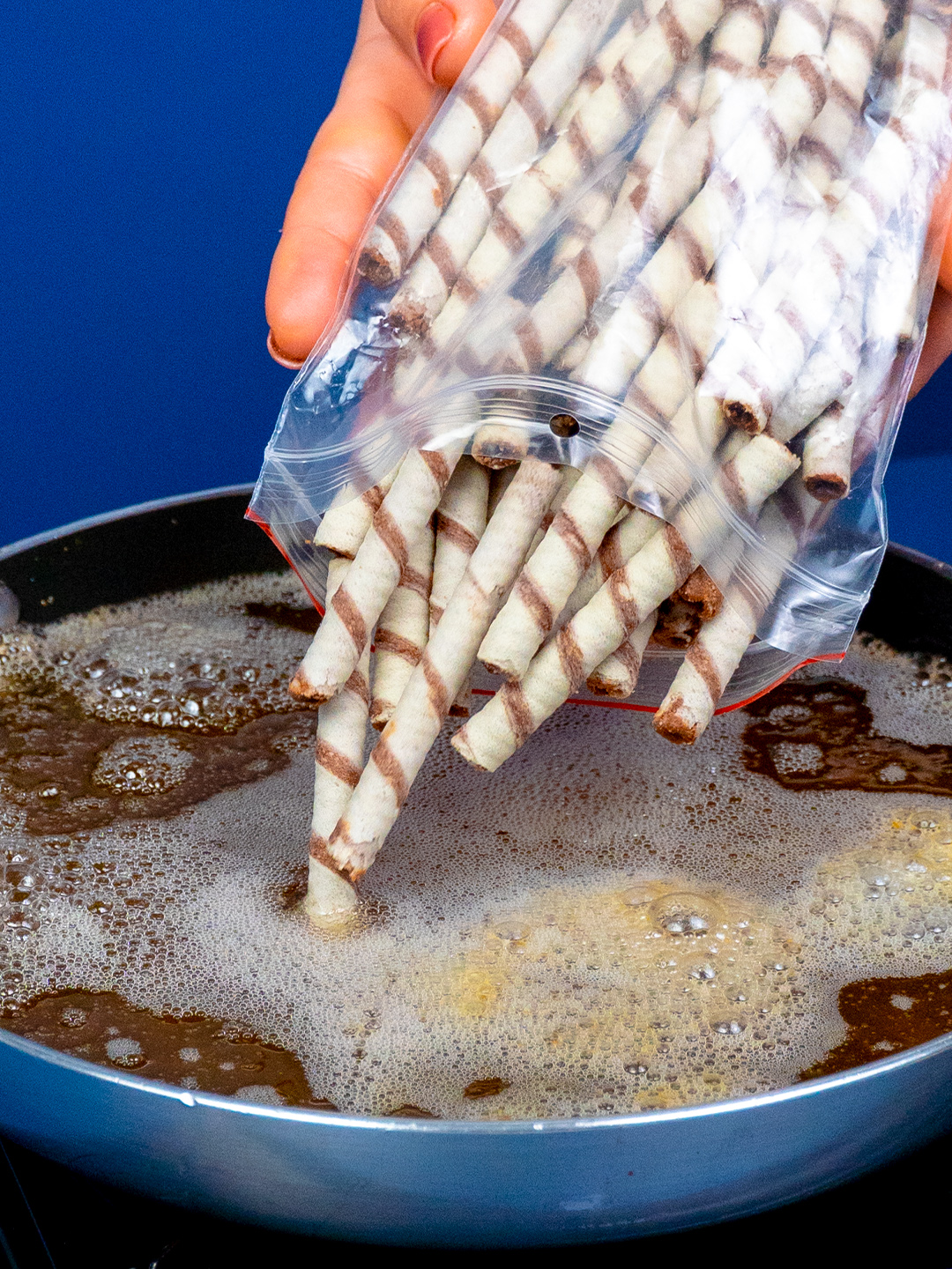 The famous no-bake dessert, ideal for New Year's Eve dinner! Ingredients: wafers rolls with cream: 700 g (25 oz) wafers rolls with cream: 300 g (11 oz) melted butter: 30 ml (1 fl oz) whipping cream: 1 l (34 pt) powdered sugar: 150 g (5.3 oz) vanilla essence: 15 ml (0.5 fl oz) mascarpone: 150 g (5.3 oz) Nutella: 100 g (3.5 oz) instant coffee: 15 g (0.5 oz) sugar: 10 g (0.4 oz) water: 30 ml (1 fl oz) ice cubes: 4 pc whipping cream: 20 ml (0.7 fl oz) wafers rolls with cream: 8 pc cocoa: 15 g (0.5 oz) mint: 4 g (0.1 oz)