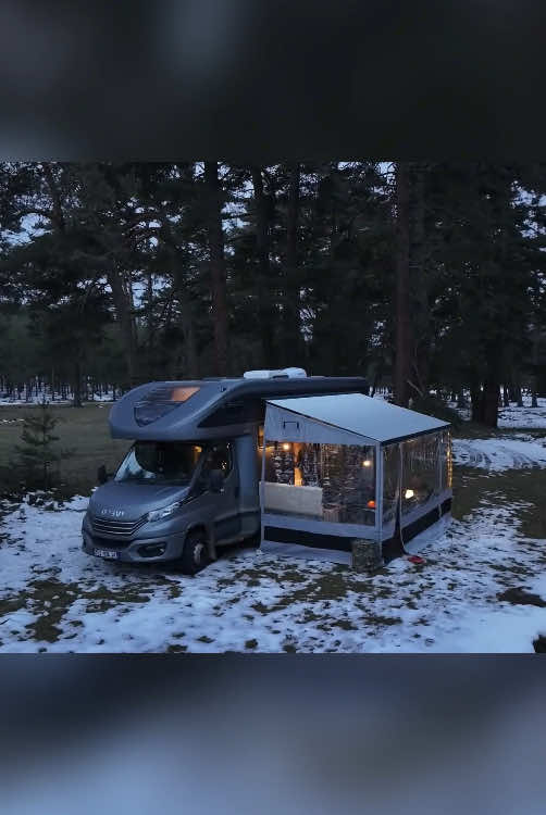 camping in the snowy forest - relaxing in a warm car