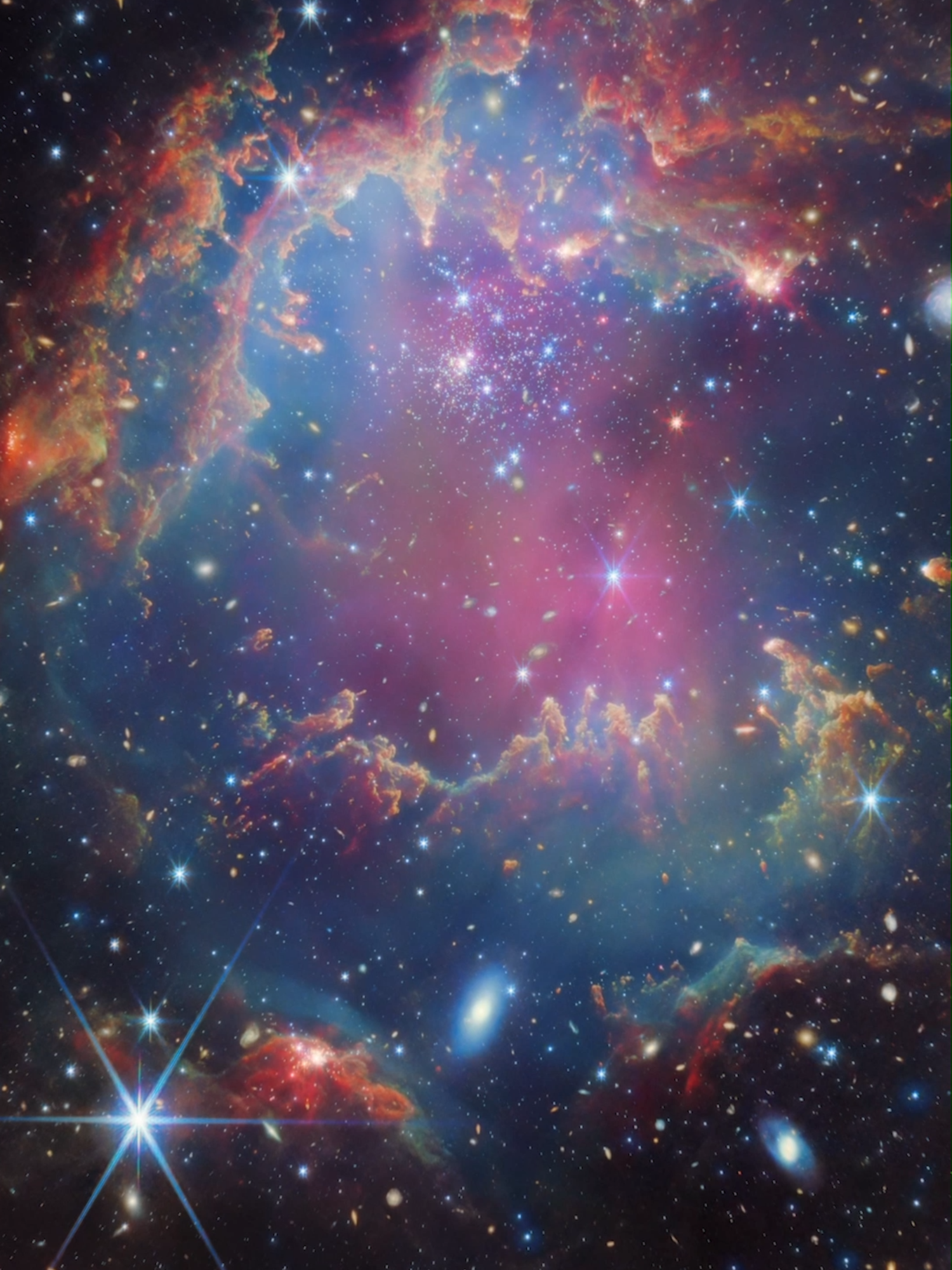 Zoom into NGC 602 with us 💫 The local environment of this cluster is a close analogue of what existed in the early Universe, with very low abundances of elements heavier than hydrogen and helium. The existence of dark clouds of dense dust and the fact that the cluster is rich in ionised gas also suggest the presence of ongoing star formation processes. This cluster provides a valuable opportunity to examine star formation scenarios under dramatically different conditions from those in the solar neighbourhood. #Space #JWST #ZoomIn