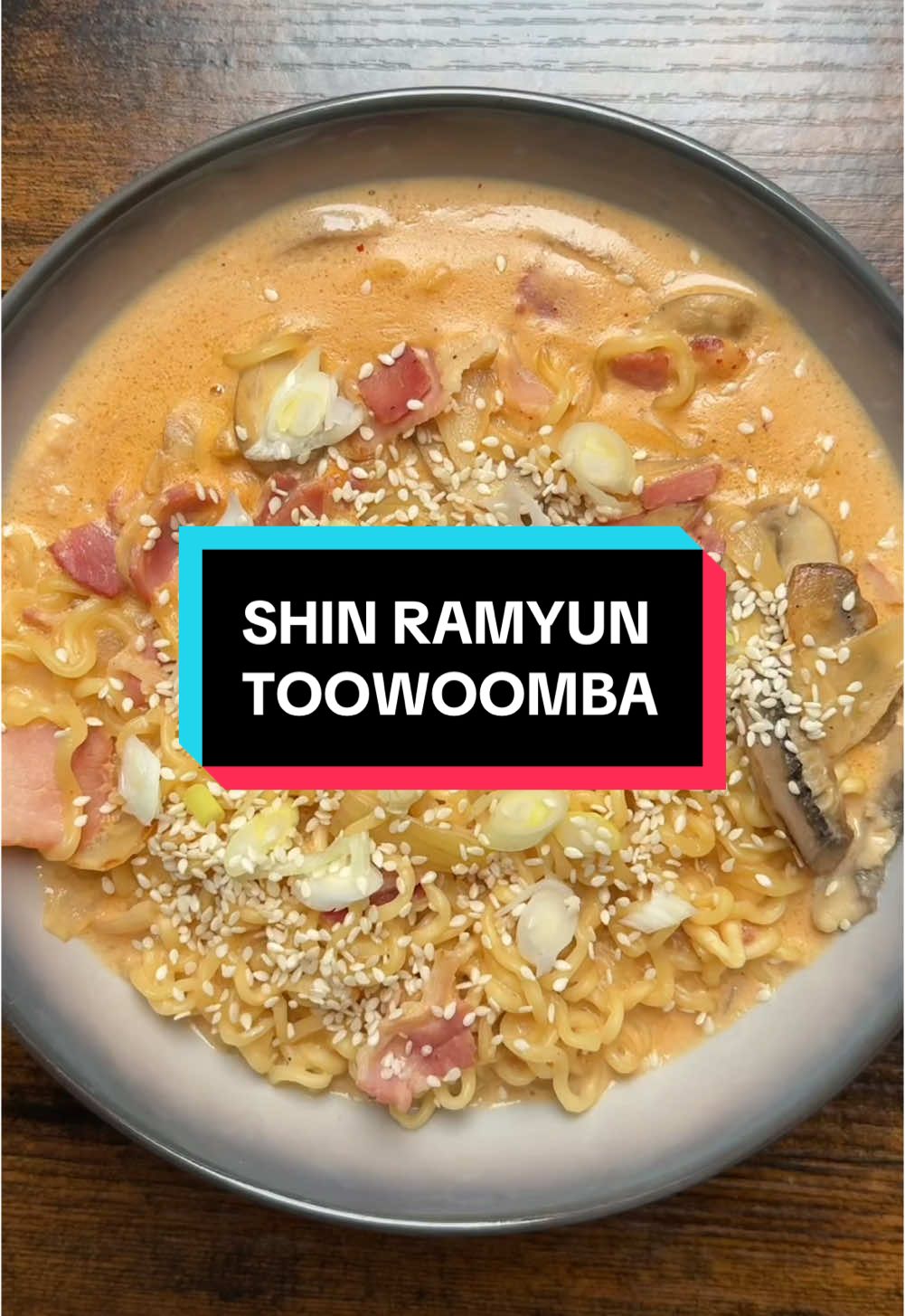 Introducing your new favourite comfort food💁🏻‍♀️   Shin Ramyun Toowoomba 💥  an epic take on the classic Shin Ramyun combining the signature spicy seasoning, milk, and cheese to create a rich and silky broth 😮‍💨 This flavour has already been released in Korea and I’m hoping it gets released in the UK too because it’s AMAZING 😭   Save this video as you’re definitely going to want to try this 👏🏻 📌RECIPE BELOW  Gather 1 pack of Shin Ramyun noodles 1 tbsp oil 1 white onion, chopped  6 garlic cloves, sliced thinly  2 slices of Smokey bacon rashes, chopped  200g mushrooms, sliced 300ml milk  1 packet of the spicy Shin Ramyun seasoning that comes with the noodles  1 slice of cheese A knob of butter Optional: sesame seeds and sliced spring onion  Method  1.) Boil the noodles according to packet instructions. Drain and set aside. 2.) In a pan, heat up the oil over a medium high heat. After a minute, add the sliced onion and garlic and cook for 2 minutes until they soften. 3.) Stir through the sliced bacon and mushrooms, and cook for another 2 minutes until the bacon becomes slightly crispy. 4.) Stir through the milk, seasoning, and sliced cheese. Bring to a boil and remove the pan off the heat once a reduced broth has formed. 5.) Stir through the cooked noodles and butter, and top with whatever seasonings you like. Enjoy warm!  #Shinramyun #Shinramyuntoowoomba #Shinramyuntoomba #Toowoomba #Toomba #Nongshim