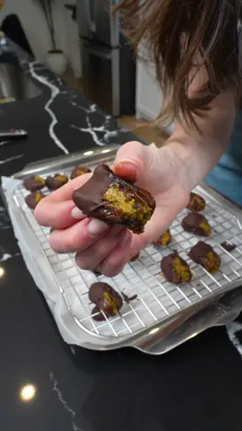 He to make pistachios stuffed dates  Ingredients: 1. 1 cup pistachios, peeled and roasted 2. 1 tbsp sugar 3. Pinch of salt 4. 20 large dates, pit removed 5. 1 cup dark chocolate chips Instructions: 1. In a food processor, add the pistachios and turn on the processor. Blend until smooth, scraping the sides down as needed. Once smooth, mix in the sugar and salt. 2. Melt the chocolate in a microwave or over a double boiler. 3. Stuff the dates with a teaspoon or two of the pistachio paste, then dip half of the date into the chocolate to coat. Place on a parchment lined sheet tray. Do this with all of the dates, then refrigerate to harden the chocolate. 4. Enjoy or store in the fridge until giving to friends! #christmascooking #holidaygift #dates #candy #cooking