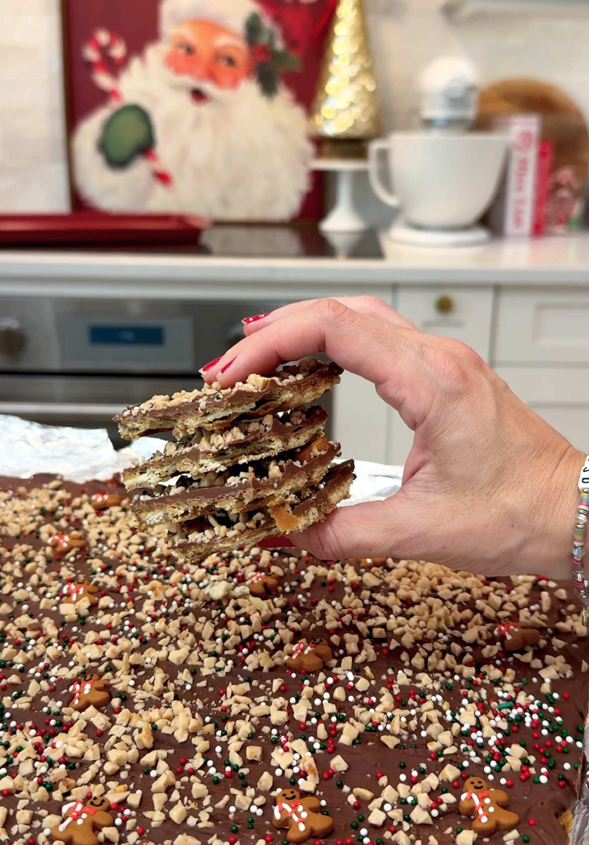 CHRISTMAS CRACK🍫🏆 have you tried it? If nor, you need to!! Full recipe is below: INGREDIENTS: - 1 package of saltine crackers - 1 c unsalted butter - 1.5 tsp vanilla extract - 1 c dark brown sugar - 2 c chocolate chips (I used milk chocolate) - 1/2 c heath bar crumbles  - Halloween sprinkles  INSTRUCTIONS: - Preheat the oven to 350 - Line a baking sheet with tin foil, folding it over the sides  - Spray generously with baking spray to avoid sticking  - Place saltine crackers in single layer on your baking sheet, breaking crackers in half as needing so that the entire bottom of the pan is filled - In a small pot, melt butter then add your brown sugar and mix until combined - Bring butter/brown sugar to a boil and allow to continue boiling for 3 minutes (be sure to continuously stir so that your caramel sauce doesn’t burn) - Remove from heat and stir in vanilla extract - Pour caramel sauce over crackers and spread in an even layer so that all of the crackers are covered with the sauce - Bake in the oven for 6 minutes and allow to cool for a minute or so - Sprinkle your chocolate chips on top and pop back into the oven for 30 seconds then remove from oven - Using a spatula, spread out the chocolate so that it is in an even layer over the caramel layer - While the chocolate is still wet, add your heath bar crumbles and sprinkles, as many or as little as you’d like! - Alllow the bars to set on the counter for 30 minutes or so and then pop into the fridge for another couple of hours to chill before cutting - Chop into bars and serve immediately OR place in an airtight container to enjoy later #holidayideas #holidaydesserts #holidayrecipes #holidaybaking #christmascrack 