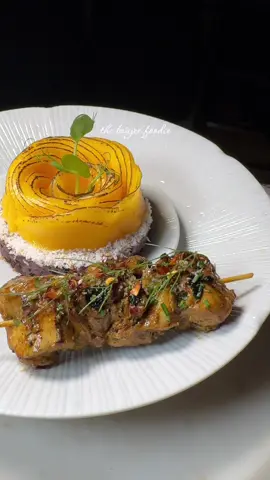 Coconut Sticky Rice, Mango Rose, Tumeric Spiced Chicken Skewers - my first official dish of the year and I’m taking you back to my Asian Heritage with this one.  You may have heard of coconut sticky rice and associate it with desserts or sweet Asian dishes but here, I show you how to pair this amazing rice with savory but retaining the sweet coconut aroma and nutty texture of this gorgeous glutinous sticky rice. Made here by mixing forbidden black gluttonous rice with white gluttonous rice for a mix of texture and color.  The coconut milk is sweetened a little with sugar to bring out its aromas and offset the salted spices chicken skewers which is prepared here by marinating skin on boneless chicken thighs in a spiced ginger and soy marinade with added tumeric for a pop of color that goes so beautifully with mango and the deep purple shade of the coconut rice which is pigmented by the overnight soak of the two rices mixed together.  I wanted to bring this dish back to life as it takes me down memory lane, with certain aspects of it that are so nostalgic to me and my childhood, but refreshed and reinvented to suit more of my culinary style now.  #stickyrice #coconutrice #blackrice #chicken #skewers #chickenrecipes #grilledmeat #tumeric #grilledchicken #asianfood #thaifood #spicedfood #plating #theartofplating #coconutmilk 