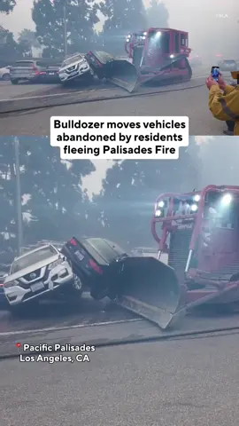 A bulldozer was needed to clear a path for firefighters who were blocked by abandoned cars from fighting the Palisades Fire on Tuesday. As tens of thousands of Pacific Palisades residents fled the rapidly growing blaze in Los Angeles County, dozens were forced to leave their vehicles on gridlocked roads behind. Tap the link in our bio for everything we know about the ongoing fight against the growing wildfire threat in Southern California. #palisadesfire #wildfire 
