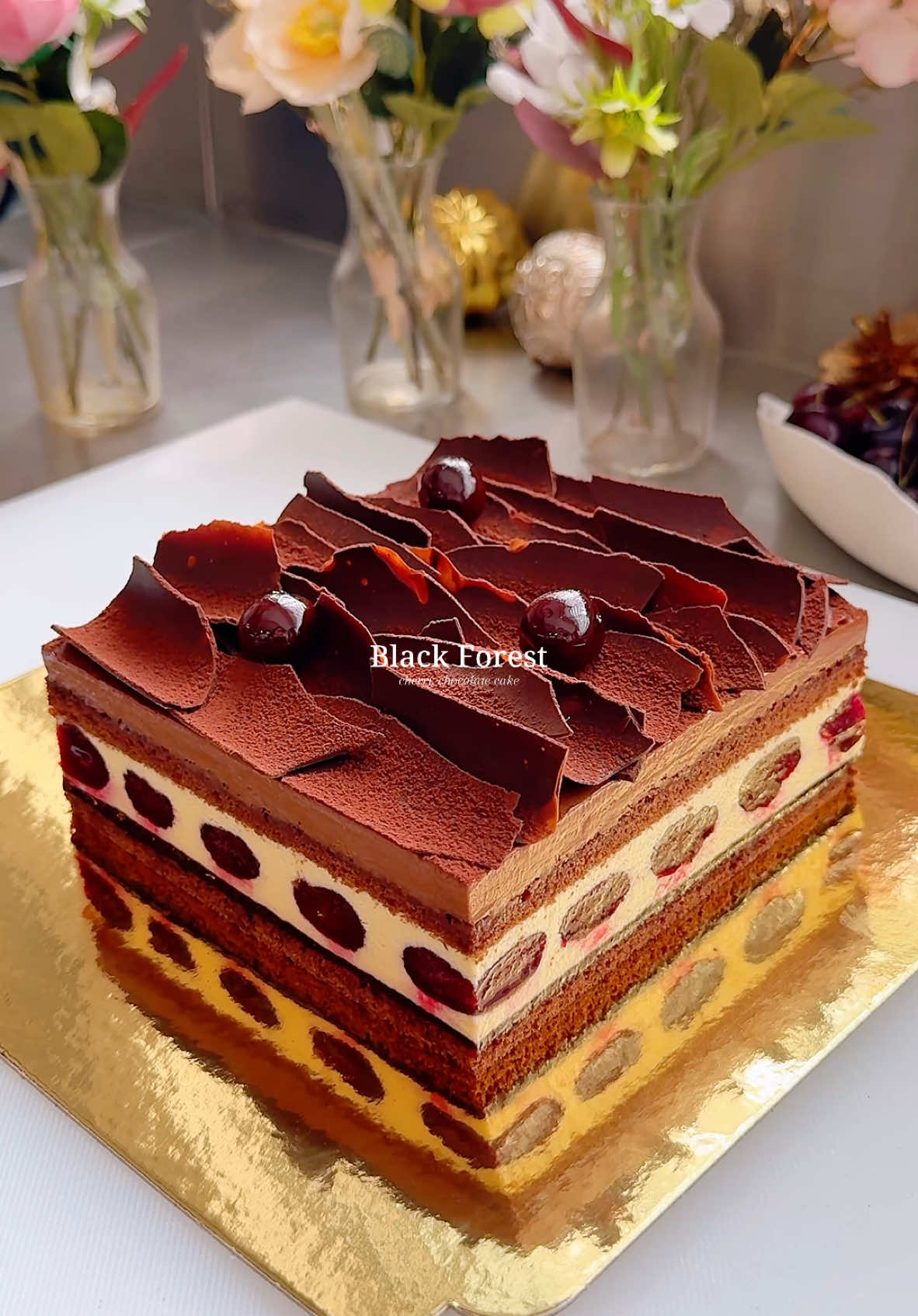 Black forest cake🍒 Moist chocolate almond sponge brushed with cherry syrup and layered with morello cherry compote, brandy vanilla cream, macerated cherries and dark chocolate mousse.  The soft chocolate cake layers combined with juicy cherries, fluffy cream and crisp chocolate shards are just heavenly- rich and intense in flavor yet surprisingly light in texture🤎 Recipe’s available on my Substack (link in bio).  #explore #cherry #chocolatecake #blackforest #cakesoftiktok #desserts 