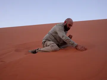 Singing sand dunes produce low-frequency sounds, resembling musical tones, caused by sand grains sliding or colliding. These sounds, ranging from hums to roars, occur in deserts worldwide, including China, the Sahara, and the U.S. The phenomenon depends on grain size, shape, and dryness, with vibrations and resonance in the sand layers amplifying the sound. Exact mechanisms remain under study. #sand #nature #deshrine