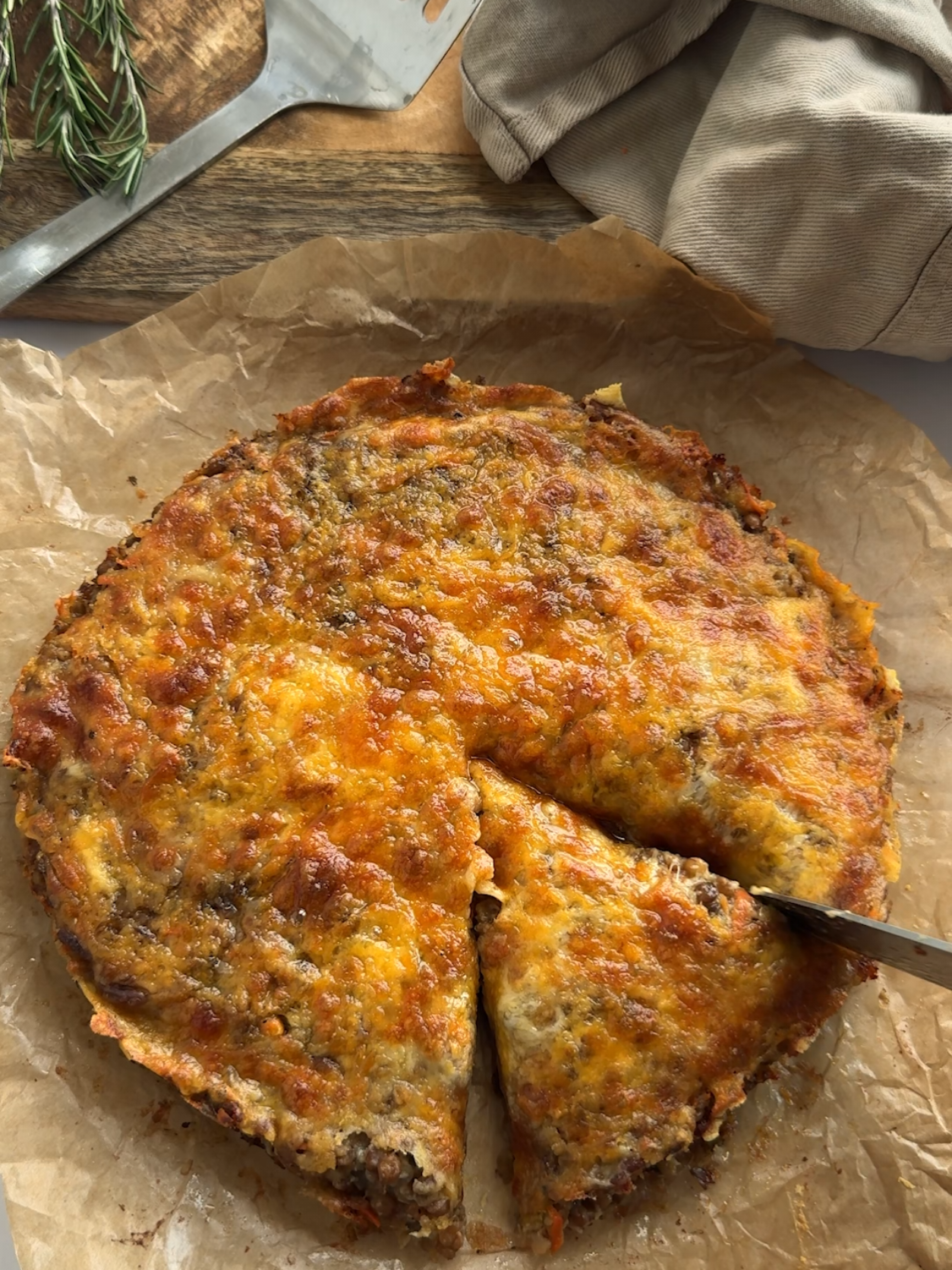 Tinned Cheesy Lentil Bake This is the first recipe in my new mini series - 3 Ways with Lentils! These are all super simple, crowd-pleasing dinners that even the lentil sceptics are going to love! I don't know if any of you remember the Cheesy Red Lentil Bake I posted a few months ago? Well this is the tinned green lentil version! There's no cooking the lentils with this one - it's just a really delicious, throw together kind of a bake that you can eat hot or cold, so it's perfect for make ahead dinners and next day lunches! If you want to prep this in advance, just make it in the morning, pop it in a baking dish and cover it in the fridge before cooking it later....and if you have any leftovers, this freezes like a dream! I have written up the recipe for this below - let me know if this one's going on the list! A x Feeds 4-6 1 red onion finely sliced 2 cloves of garlic finely chopped 2 x 400g tins of green or brown lentils, drained 2 tbsp mixed herbs 1 medium grated carrot 120g of fresh white breadcrumbs  200ml -220ml Vegetable stock 100g of grated cheddar cheese (plus extra to sprinkle over the top) Heat a drizzle of oil in a non-stick frying pan. Add the onion and fry for 5 minutes on a medium heat until soft. Stir in the chopped garlic for the final minute. Heat the oven to 190C fan Tip the onion and garlic into a mixing bowl with the drained lentils, mixed herbs, grated carrot, breadcrumbs, (200ml) stock and cheese. Season generously with salt and pepper. Work the breadcrumbs and stock into the other ingredients with a wooden spoon. Spend a minute or two on this until all the ingredients have combined and you have a dry sticky consistency. Tip the mixture into a lined baking dish (23cm across) Press the filling down firmly with the back of a spoon, ensure it's packed down, level and pushed into all the edges. Sprinkle grated cheese over the top Bake in the oven for 35-40 minutes or until the cheese has turned golden brown and starting to crisp. Leave the bake to cool and firm up for around 15 minutes before lifting it out by the edges of the baking paper and cutting it into slices. #lentils #lentilrecipe #vegetarian #delicious #goodfood #easydinner #budgetcooking #moneysaving #homemade #comfortfood #sotasty #quickrecipe #familydinner #homeideas #cookingonabudget 