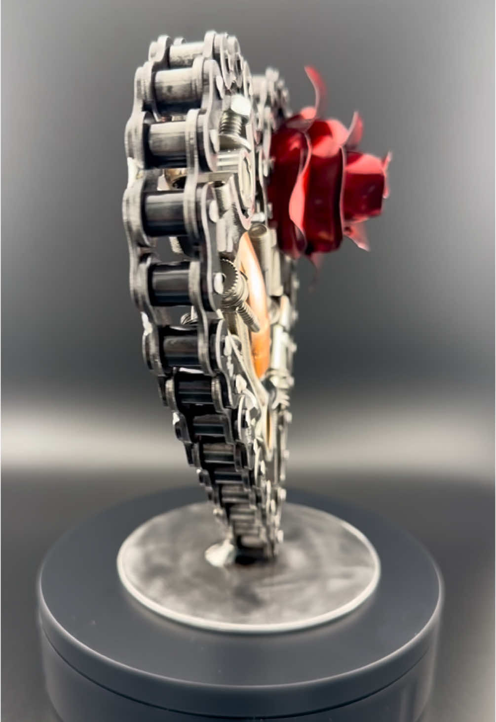 Built from car parts, tools, and upcycled metals, the Spare Eternity heart by Dark Metal Art celebrates individuality and durability. This build features a hand-shaped electric red rose. Each piece is carefully selected and arranged, ensuring that no two builds are the same. Coated with a protective clear finish, your art will shine as brightly as the passion behind it—forever. ❤️ #darkmetalart #Love #anniversary #heart #art #moto #motogirl #mechanic 