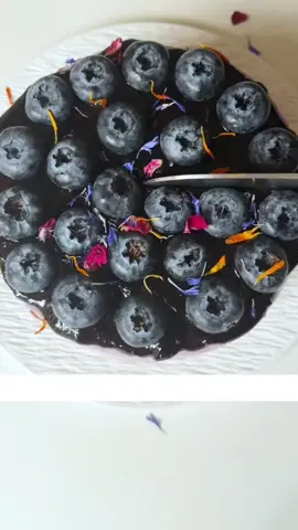 Blueberry Soft-Centered Basque Cheesecake Recipe 👇 👉 Ingredients: For the Blueberry Sauce: 350g fresh blueberries 50g granulated sugar 3g lemon juice For the Cheesecake Filling: 350g cream cheese (softened) 56g granulated sugar 180g heavy cream (warmed to 35°C) 15g milk (warmed to 35°C) 3 large eggs (room temperature) 8g cornstarch 110g blueberry sauce (from above) For the Blueberry Topping: 110g heavy cream 28g blueberry sauce 7g granulated sugar For Garnish (Optional): Fresh blueberries Edible flowers Powdered sugar Directions: 1. Prepare the Blueberry Sauce: In a saucepan, combine the fresh blueberries and sugar. Use a spoon or masher to crush the berries slightly. Cook over medium heat, stirring constantly, until the mixture thickens (about 10-15 minutes). Add the lemon juice and stir to combine. Remove from heat and let it cool. You should have about 250g of blueberry sauce. 2. Prepare the Cheesecake Filling: Preheat your oven to 230°C (450°F). Grease a 6-inch round cake pan and line it with parchment paper. In a large bowl, beat the softened cream cheese until smooth. Add the sugar and cornstarch, mixing until fully combined. Add the eggs one at a time, mixing well after each addition. Gradually add the warm heavy cream and milk, mixing until smooth. Strain the batter through a sieve to remove any lumps. Fold in 110g of the cooled blueberry sauce until evenly incorporated. 3. Bake the Cheesecake: Pour the batter into the prepared pan. Bake for 23 minutes, or until the top is deeply caramelized but the center is still soft and jiggly. Remove from the oven and let it cool completely in the pan. Once cooled, cover and refrigerate overnight. 4. Prepare the Blueberry Topping: In a bowl, whip the heavy cream, blueberry sauce, and sugar until soft peaks form. Spread the whipped cream mixture evenly over the chilled cheesecake. Drizzle additional blueberry sauce on top and garnish with fresh blueberries and edible flowers if desired. Dust lightly with powdered sugar before serving. This Blueberry Soft-Centered Basque Cheesecake is a tangy, creamy delight! The soft, gooey center is packed with vibrant blueberry flavor, while the caramelized top adds a beautiful contrast. Perfect for dessert lovers who enjoy a balance of sweet and tangy flavors. Prep Time: 30 minutes | Cook Time: 23 minutes | Chilling Time: Overnight | Total Time: 1 hour + chilling | Servings: 8-10 | Kcal: 320 per slice #creatorsearchinsights #Recipe #EasyRecipes #yummy #yum #cookingathometiktoktv #foryoupage 