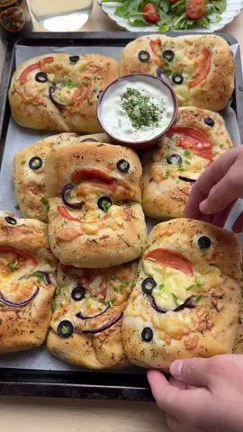 THE BEST SOFT TUNA BREAD RECIPE  #food #Recipe #bread #tuna #tasty #fy #fyp #foryoupage #foryou DOUGH 500 g flour (all-purpose flour) 8 g instant yeast 15 g granulated sugar (1 tablespoon) 8 g salt (1⅓ teaspoon) 35 ml sunflower oil 250 ml water (lukewarm) TUNA MIXTURE 15 ml olive oil 100 g red onion (1 red onion, finely chopped) 225 g grilled red peppers (2 grilled peppers, sliced) 75 g black olives (sliced) 1.5 g salt (¾ teaspoon) 3 g red bell pepper powder (1 teaspoon) 3 g garlic powder (1 teaspoon) 3 g onion powder (1 teaspoon) 2 g black pepper (⅔ teaspoon) 2 g Italian seasoning (1 teaspoon) 140 g tuna (tuna in sunflower oil) 150 g grated cheese 70 g tomato paste (1 small can) cheddar cheese (10 slices) GARNISH 100 g herb butter grated cheese black olives tomato red onion Mix the flour, yeast, sugar, salt, sunflower oil, and lukewarm water in a large bowl. Knead the dough for 10-12 minutes until smooth. Cover the bowl and let the dough rise in a warm spot for 1 hour or until it doubles in size. Heat the olive oil in a skillet over medium heat. Add the chopped red onion and sauté for 2 minutes. Add the grilled peppers, black olives, salt, red bell pepper powder, garlic powder, onion powder, black pepper, and Italian seasoning. Cook for another 2 minutes. Stir in the tuna and cook briefly until combined. Add the grated cheese, cook for 1 more minute, and then turn off the heat. Let the mixture cool. Deflate the dough and divide it into 10 equal pieces (about 80 g each). Shape into balls. Roll each ball of dough into a square on a floured surface (15 by 15 cm). Spread a thin layer of tomato paste on the dough. Place a slice of cheddar cheese on top, followed by 60 g of the tuna mixture. Fold one side of the dough over the filling, then fold the other side so the edges slightly overlap. Fold the top down and roll tightly, sealing the edges well. Place the filled rolls on a baking sheet lined with parchment paper. Brush the tops with herb butter and garnish with grated cheese, black olives, tomato, and red onion. Let the dough rise for 30 minutes or until they double in size. Preheat the oven to 200°C (392°F). Bake the bread for 12-18 minutes until golden brown. Cover the bread immediately with a clean tea towel after baking to keep them soft. Tips: Ensure the water is not too hot, as it will kill the yeast. Lukewarm (around 37-40°C) is ideal. If your home is cool, let the dough rise in an oven briefly preheated to 30-40°C and then turned off. Alternatively, place the dough above a bowl of warm water. Roll the dough evenly to avoid uneven thickness after folding. Press the edges firmly to prevent the cheese and filling from leaking during baking. Cover the rolls with a slightly damp cloth or plastic wrap during the second rise to prevent the dough from drying out. Lightly melt the herb butter for easier and more even application. Slice the tomato and red onion thinly for a polished presentation. These rolls pair perfectly with a refreshing yogurt dip or a spicy sauce.