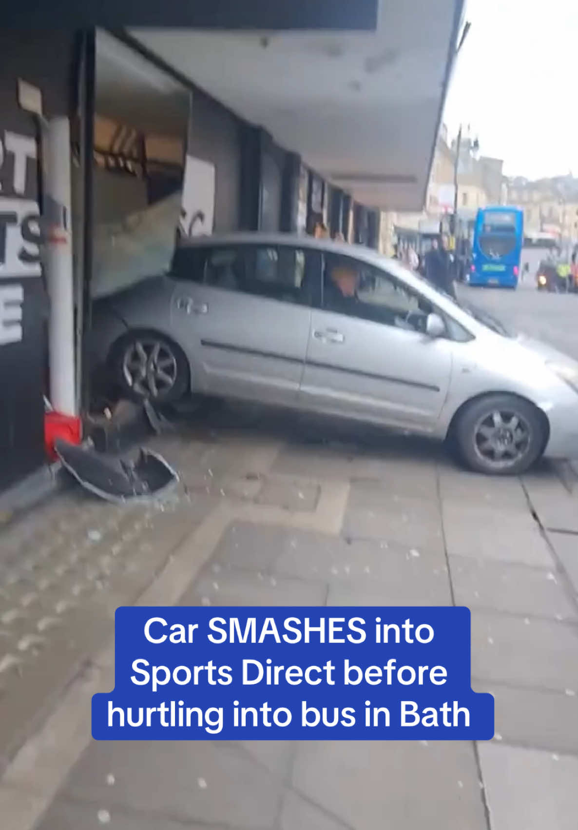 This is the bizarre moment a car rammed into a Sports Direct store in Bath - along with multiple other cars and a bus.  One man was taken to hospital after the incident on Friday lunchtime.  🎥 Jam Press #bath #crash #carcrash #sportsdirect #news #somerset 