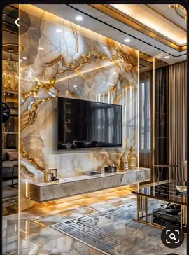 The image features a modern, luxurious living room with a large television mounted on a marble-like wall. The room is adorned with golden accents and has a sleek, elegant design. #advestments #f 