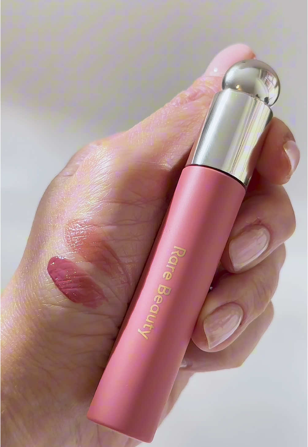 @Rare Beauty - Soft Pinch Tinted Lip Oil (shade: Hope) An innovative lip jelly that transforms into a lightweight, nourishing oil. It starts off glossy and leaves a long-lasting tint on your lips while gently plumping them. Best of all, it stays comfortable all day without ever feeling sticky. I picked this up because it’s the perfect combination of a long-wearing lip stain and a shiny finish of lip gloss. | Copyright © 2025 WaxyBeauty | [Rare Beauty lip oil,  makeup essentials] #rarebeauty #beautygram #pinkpackaging #pinklipgloss #viralmakeup #trendingmakeup #lipproducts #thatgirlaesthetic #makeupcloseup