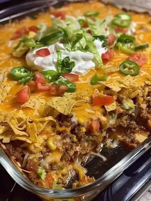 Walking Taco Casserole 😋😋 Ingredients 1 1⁄2 pounds Ground Beef 1⁄3 large Onion, chopped 1 can Green Chilies, small can 1 can Enchilada Sauce 2 ounces Cream CheeseIngredients 1 bag Fritos Corn Chips 1 bag Shredded Cheese 3⁄4 cup Lettuce, shredded 1⁄2 cup Tomato, fresh, diced 16 ounces Salsa 8 ounces Sour Cream Directions Brown ground beef with onion. Add green chilies, enchilada sauce and cream cheese. In a 9×13 pan, repeat layers as follows: Fritos chips Meat Mixture Shredded Cheese. Bake at 350 for 15-20 minutes or until cheese is bubbly. Top individual servings with lettuce, tomatoes, salsa, sour cream as desired.