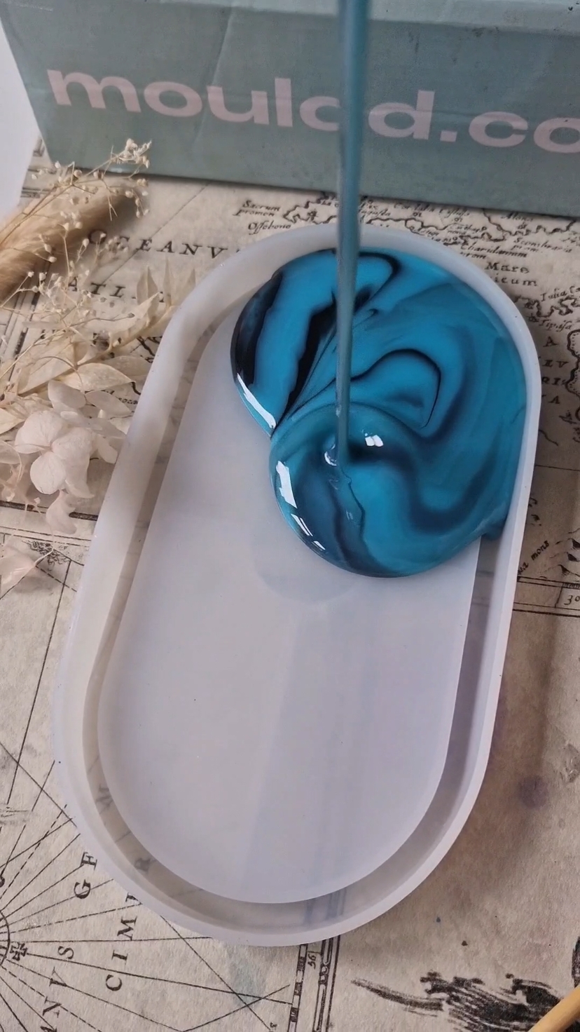 The dreamiest marbling. Does anyone else get hypnotised watching resin being poured? This Teal and black combination is so modern  Using @mouldd_resin epoxy resin and oval silicone tray These tray are so handy for hot drinks, nik naks, perfume holder the list goes on Custom order yours today #marbling #hypnoticart #Mesmerising #resinpour #pouring #moderndecor #moderndesign 