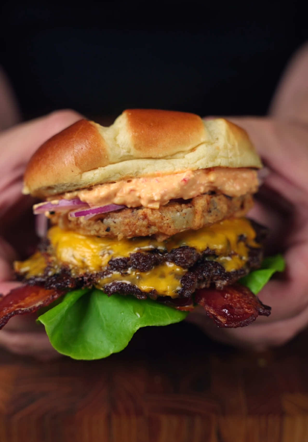 Today’s a big burger day, and there’s nothing wrong with that! I’ve been back on my Intermittent fasting kick, and the days where I’m doing one meal, we can get a little fancy as long as we still use quality ingredients! Smoked Smash burgers are super easy to make and recommend them for this! Just form the beef into 3-4 oz balls and pop them in the smoker for 20-30 mins at the lowest temp possible!  The it’s time to head to the @recteq SmokeStone and cook these bad boys up! Now here’s what you need for the Tomatoes! Fried Green Tomatoes: • 1 cup Flour • 1 tsp smoked paprika • 1/2 tbsp garlic powder • 1/2 tbsp onion powder • 1/2 tsp each of salt and pepper • 2-3 eggs beaten • heirloom fried green tomatoes Just slice them into 1/4 in slices, dip them in seasoned flour, then in the egg wash, and back into the flour to coat! After that it’s time to fry at 375°F for 4-6 minutes! But it may take a little longer to get golden brown!  For toppings, I used: • @Melinda’s Hot Sauce Spicy Garlic Parmesan sauce • Lettuce • Bacon • two Patties with cheese • julienned dill pickle and onion • pimento cheese on the top bun! Give this a try!! #burger #burgerlover #burgerlife #burgerrecipe #smashburger #friedgreentomatoes #sandwich #Recipe #food #Foodie #foodiegram #foodiesofinstagram #fyp #foryou
