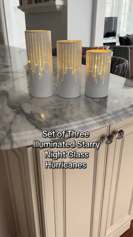 I absolutely love how beautiful this set of three illuminated starry night glass hurricanes are. They have 15 micro light strands inside of each glass hurricane with mirrored finished battery packs. They have a 6 hour timer setting and take AA batteries. Perfect addition to your decor. #homedecor #decor #beautiful #pretty #ambiance #lighting #tiktokshop #musthaves #fyp 