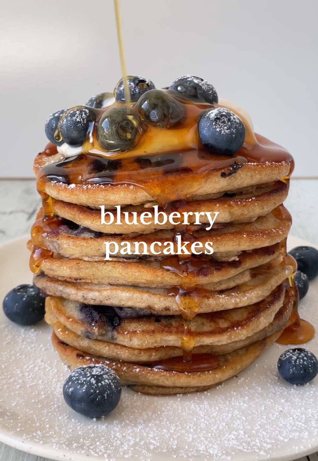 Blueberry Pancakes 🥞🫐 Here's the perfect pancake stack to make for your Valentine 😌✨ They're light and fluffy with warm bursts of blueberries in each bite 💙💙   Makes: 2 serves  Ingredients 1 cup unsweetened soy milk  2 tsp lemon juice 2 tsp vanilla extract 1 tsp lemon zest  1 cup plain all-purpose flour 2 tbsp white sugar 2 tsp baking powder  1/2 tsp ground cinnamon 1/4 tsp sea salt  125g or 1 punnet of fresh blueberries, plus more to serve * (see notes)  Butter or oil, for frying To serve: Yogurt or whipped cream Maple syrup Icing sugar  Method:  1. Combine the milk, lemon juice, vanilla extract and lemon in into a bowl. Mix well. 2. Add in the flour, sugar, baking powder and salt. Whisk until just smooth. Gently fold through the blueberries.  3. Heat a frypan over medium heat and heat 1 tbsp oil or butter. Once hot, spoon about 1/4 cup of batter in to form each pancake. Cook for 2-3 minutes until bubbles form then flip and cook for another 1-2 minutes. 4. Serve with extra blueberries, yogurt and maple syrup. Enjoy immediately while warm 💙 Notes:  * Yes you can use frozen blueberries, do not thaw them!! Another thing you can do if you don’t want them to bleed into the batter is to coat with a light layer of flour first before gently folding through. #vegan #plantbased #EasyRecipe #recipeidea #homemade #pancakes #blueberry #blueberrypancakes #asmrfood #pancakerecipe #dessertrecipe #veganpancakes 